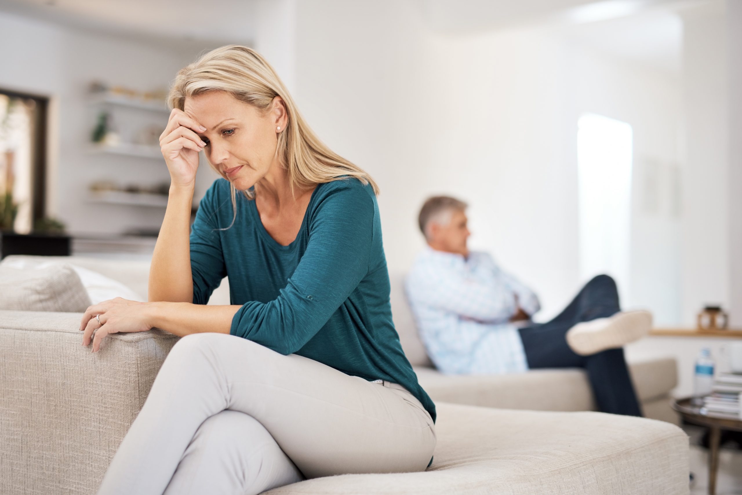 These fights are becoming a regular thing. a mature woman looking despondent after having a fight with her husband at home.